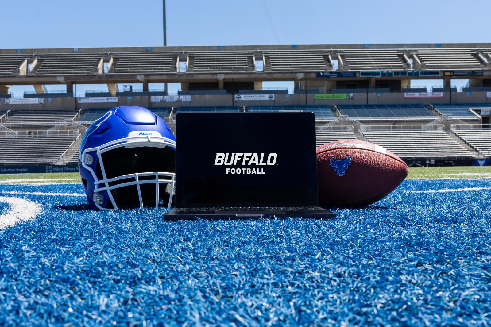 Laptop computer between a football helmet and football