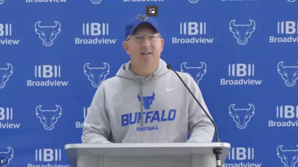 Pete Lembo speaking at a podium