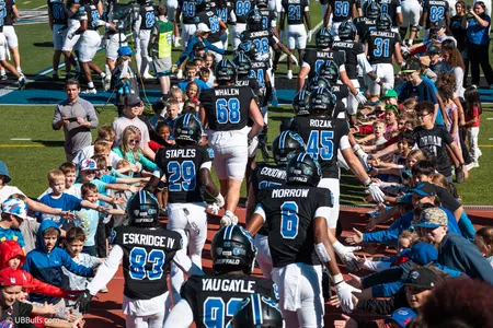 YOUNG UB FANS HIGH-FIVE THE TEAM