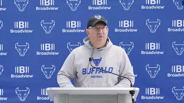 Pete Lembo speaking at a podium