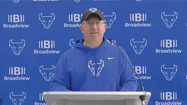 Pete Lembo speaking at a podium