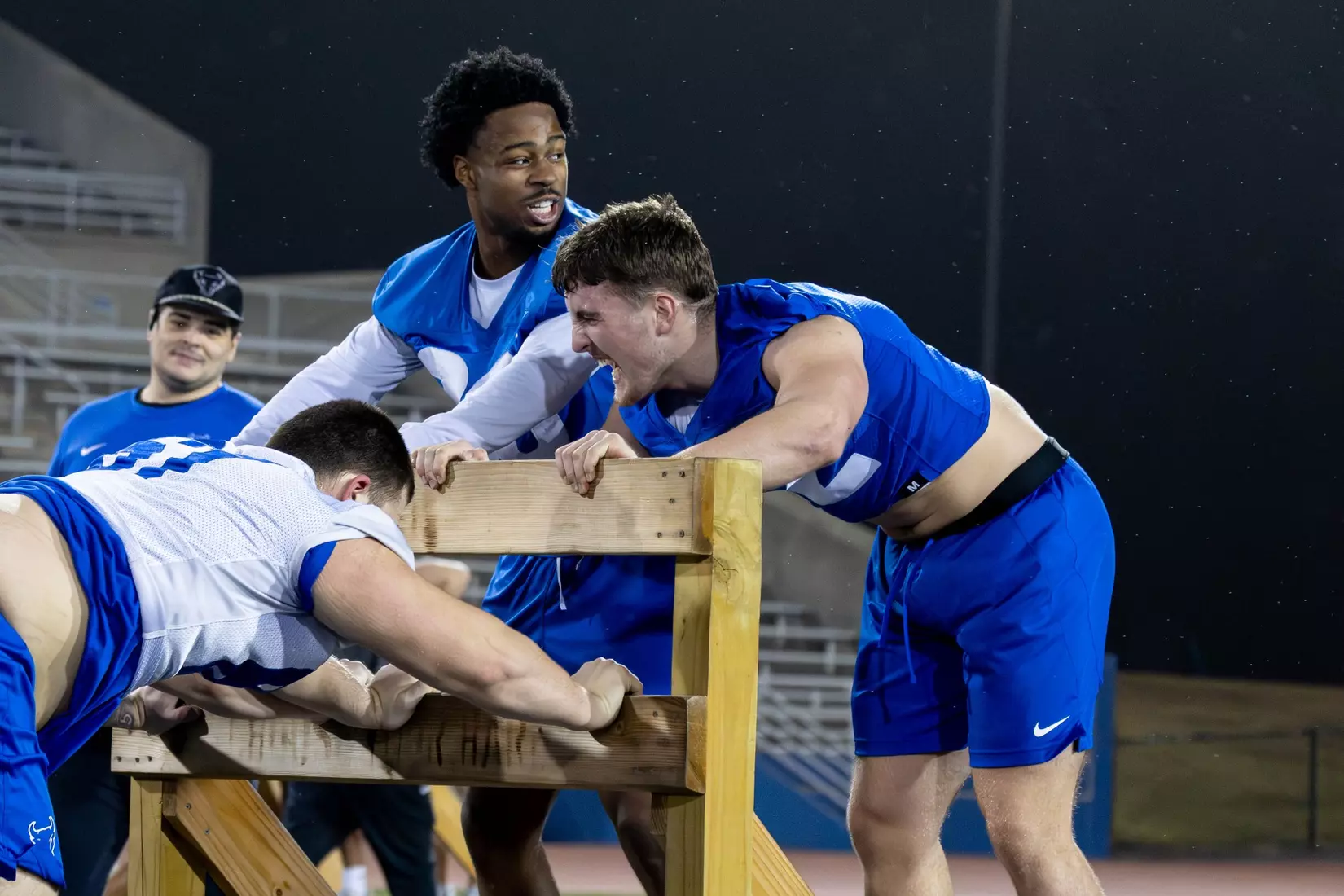 Players pushing a sled