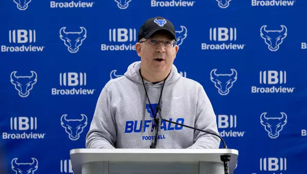 Pete Lembo speaking at a podium
