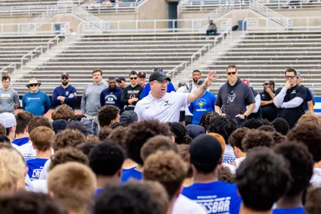 Head Coach Pete Lembo addressing players at a camp