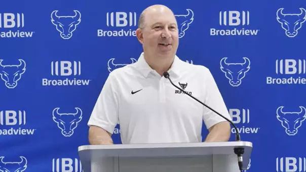 Pete Lembo speaking at a podium