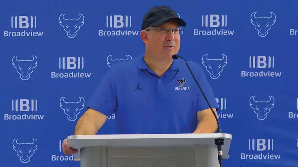 Pete Lembo speaking at a podium