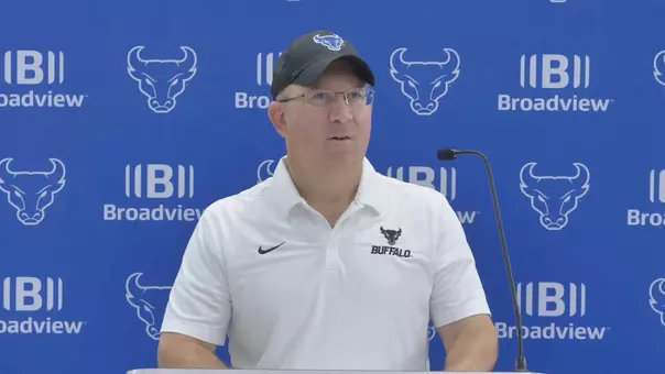 Pete Lembo speaking at a podium