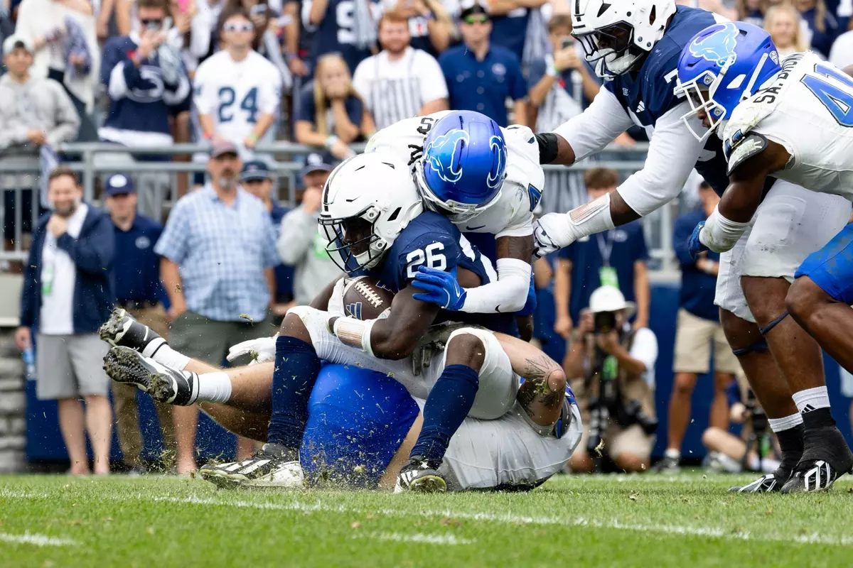 Buffalo players tackling Penn State player