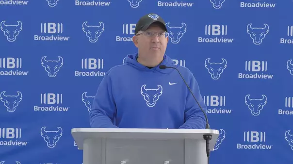 Pete Lembo speaking at a podium