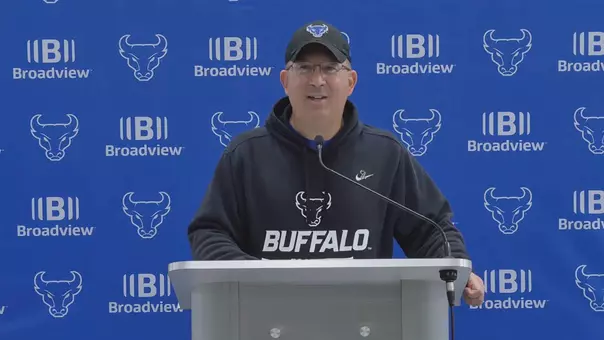 Pete Lembo speaking at a podium