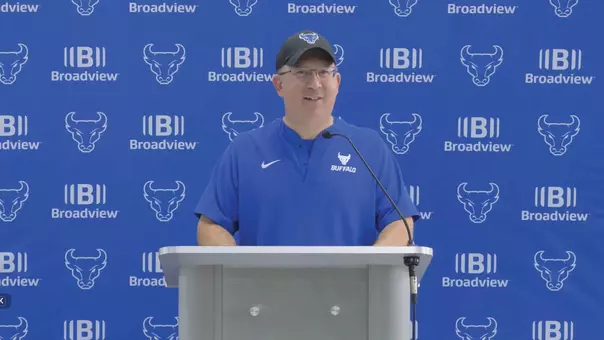 Pete Lembo speaking at a podium