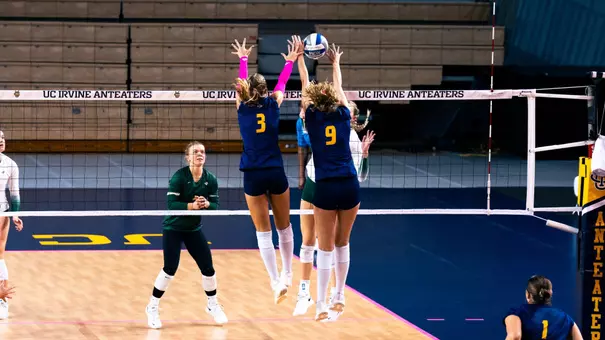 Abby Pekrul and Lois Hansen go up for a double block in an NCAA women's volleyball match against Sac State.