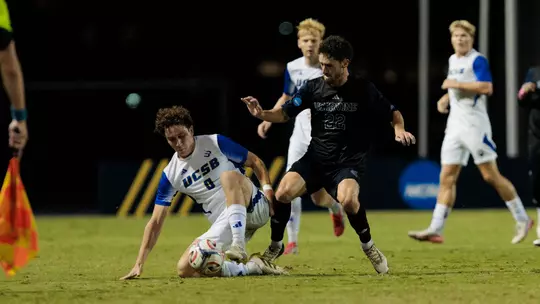 Shane Kaemerle tackles a ball from a UC Santa Barbara player in a 2026 match