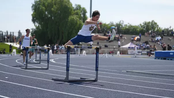 Roman Mendoza leaps over a hurdles