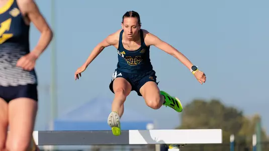 Anna Soares jumps over a barrier in the steeplechase