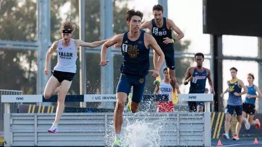 Joshua Schuld running out of the water pit in the steeplechase