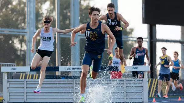 Joshua Schuld running out of the water pit in the steeplechase