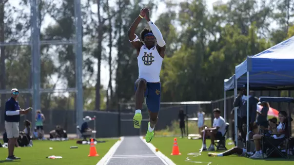 Kenechukwu Okonkwo in air during a triple jump attempt