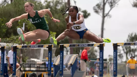 Jazzmine Davis jumps over a hurdle