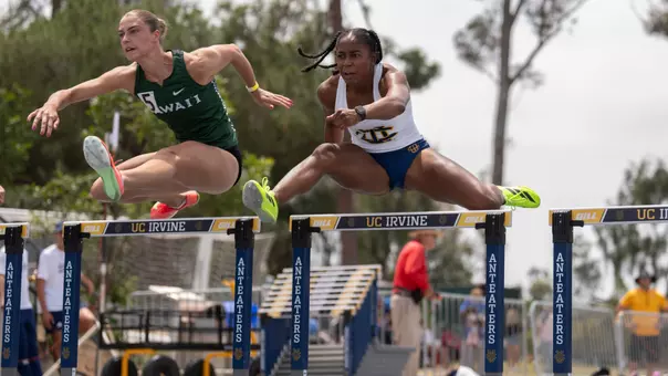 Jazzmine Davis jumps over a hurdle