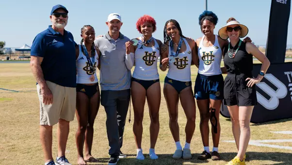 Women's track and field heptathletes and coaches pose for a photo after the Big West Championships