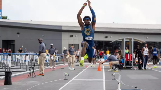 Kenechukwu Okonkwo in mid-air during a triple jump attempt