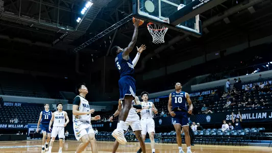 Ben Egbo goes for a layup with Josiah Johnson looking on in a game vs. Malaysia in the 2026 Williams Jones Cup