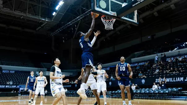 Ben Egbo goes for a layup with Josiah Johnson looking on in a game vs. Malaysia in the 2026 Williams Jones Cup
