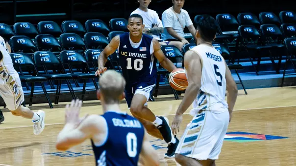 Josiah Johnson drives into the frontcourt in a 2026 William Jones Cup game vs. Malaysia