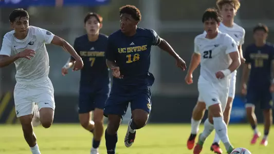 Isaac Powell drives through a hoard of Oregon State Beavers in the season-opening match of 2026 in Anteater Stadium