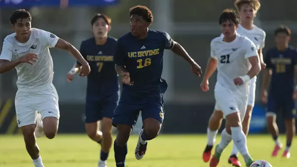 Isaac Powell drives through a hoard of Oregon State Beavers in the season-opening match of 2026 in Anteater Stadium
