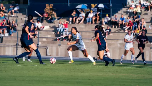 Jenika Davis dribbles through the Utah Tech defense in a match in Anteater Stadium