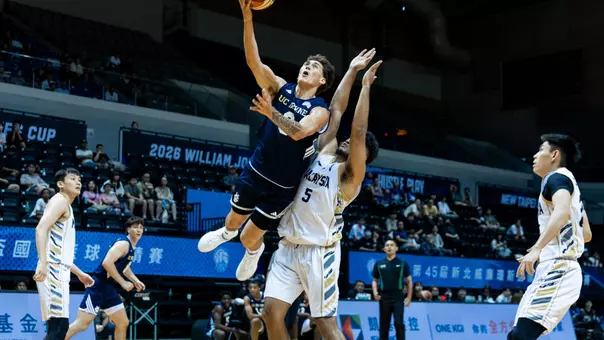 Tama Isaac soars through the air in a William Jones Cup matchup vs. Malaysia