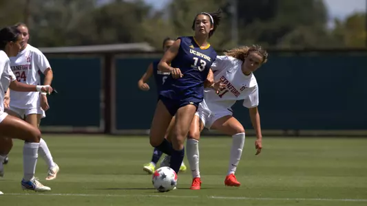 Mimi Yamamoto dishes a pass in a road match vs. Stanford