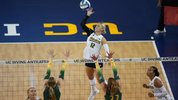 Action photo of Madison Triplett on a back row attack in UCI women's volleyball's exhibition match against Concordia
