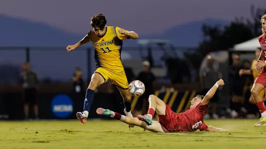 Gage Lyons fights through the LMU defense in a 2026 match at Anteater Stadium