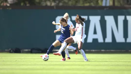 Lianna Tsabur takes on two Stanford defenders in a 2026 road match