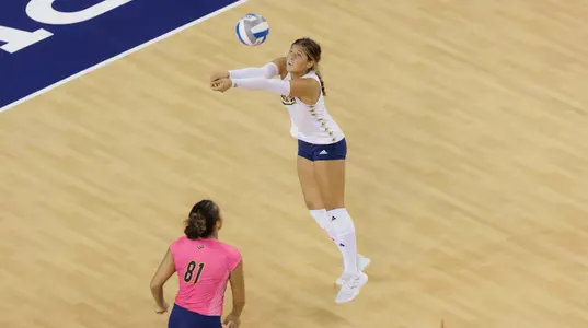 Whitney Wallace digs the ball during an NCAA women's volleyball match.