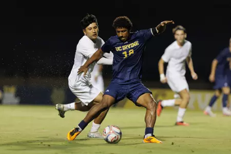 Isaac Powell dangles in front of a UNLV player in a 2026 match in Anteater Stadium
