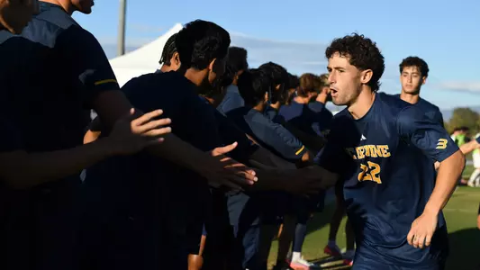 Shane Kaemerle cheers with his teammates prior to a match in Anteater Stadium vs. Missouri State