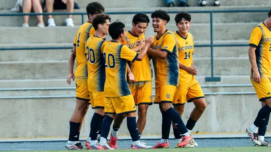 Brady Treinen celebrates with his teammates following a goal vs. San Diego in Anteater Stadium