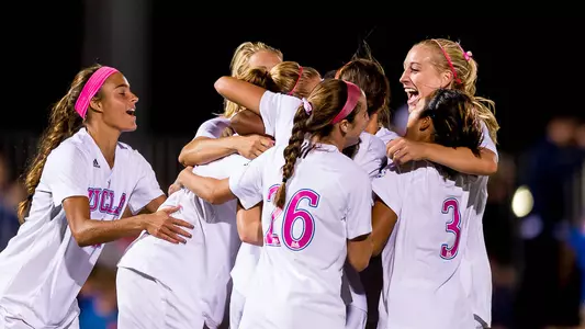 The Bruins mob Sam Mewis after a goal (photo by Scott Chandler)
