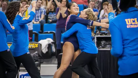 Sydney Sawa celebrates after her 10.0 floor