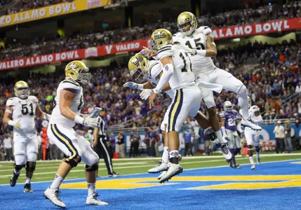 The Bruins celebrate a 3rd quarter TD (photo courtesy Getty Images)