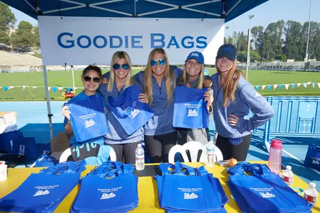 UCLA student-athletes volunteered to work Drake Stadium activity booths before the start of the ‘Dribble.’
