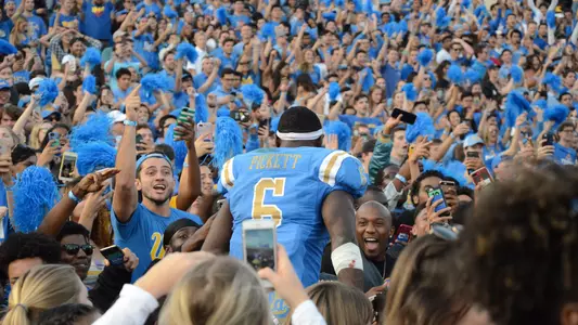 Adarius Pickett celebrates with the student section after the USC game (photo by Greg Turk)