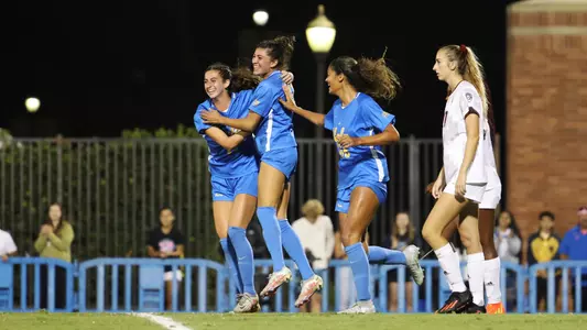 Madelyn Desiano celebrates with Lexi Wright and Reilyn Turner