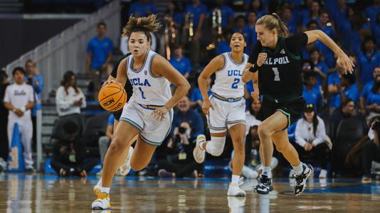 Kiki Rice dribbles up the court against Cal Poly