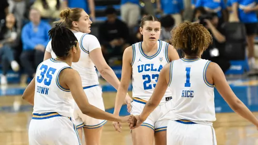 Cam Brown high five Kiki Rice, Gabriela Jaquez_vs. UC Riverside (Nov. 9, 2023)