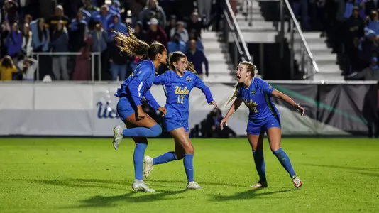 Reilyn Turner, Lexi Wright and Ally Cook celebrate a UCLA goal